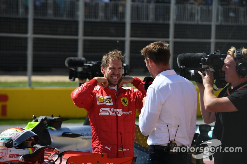 Sebastian Vettel, Ferrari, talks to Jenson Button, Sky Sports F1, after securing pole