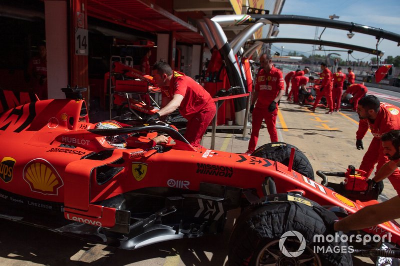 Sebastian Vettel, Ferrari SF90, is returned to the garage