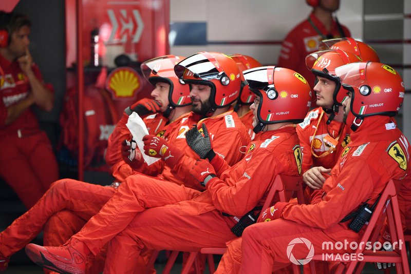 The Ferrari pit crew rest between stops