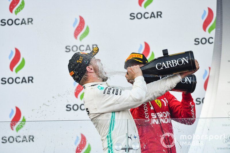 Valtteri Bottas, Mercedes AMG F1, 1st position, blasts himself with Champagne on the podium and Sebastian Vettel, Ferrari, 3rd position, joins in