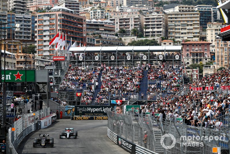 Romain Grosjean, Haas F1 Team VF-19, leads Lewis Hamilton, Mercedes AMG F1 W10