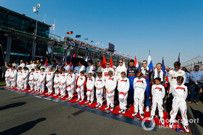 Grid Kids lined up with the drivers for the national anthem