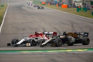 Kimi Raikkonen, Alfa Romeo Racing C38, battles with Romain Grosjean, Haas F1 Team VF-19