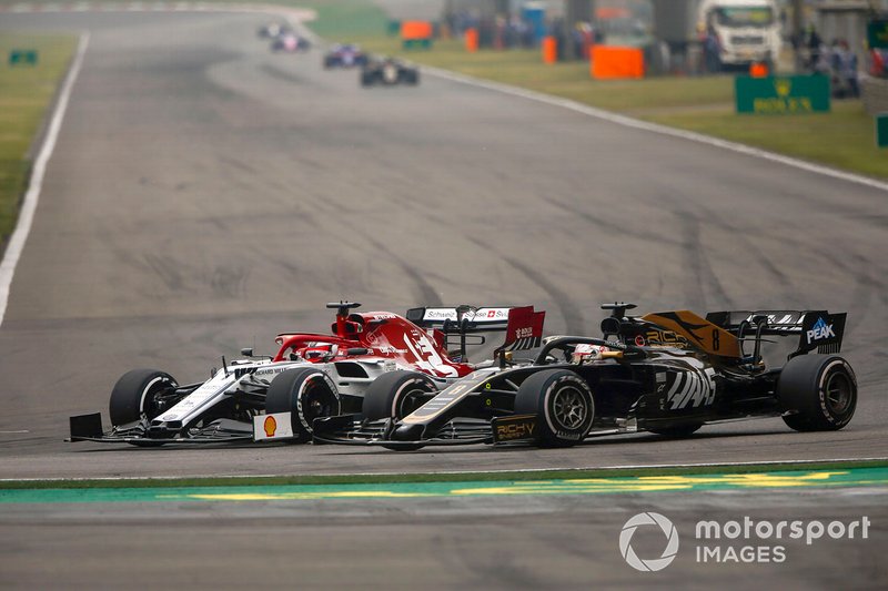 Kimi Raikkonen, Alfa Romeo Racing C38, battles with Romain Grosjean, Haas F1 Team VF-19