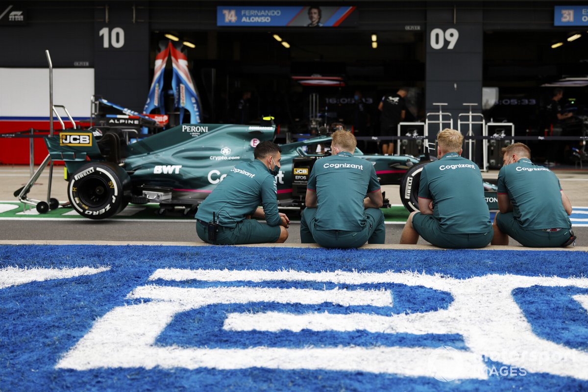 Aston Martin team members in the pit lane