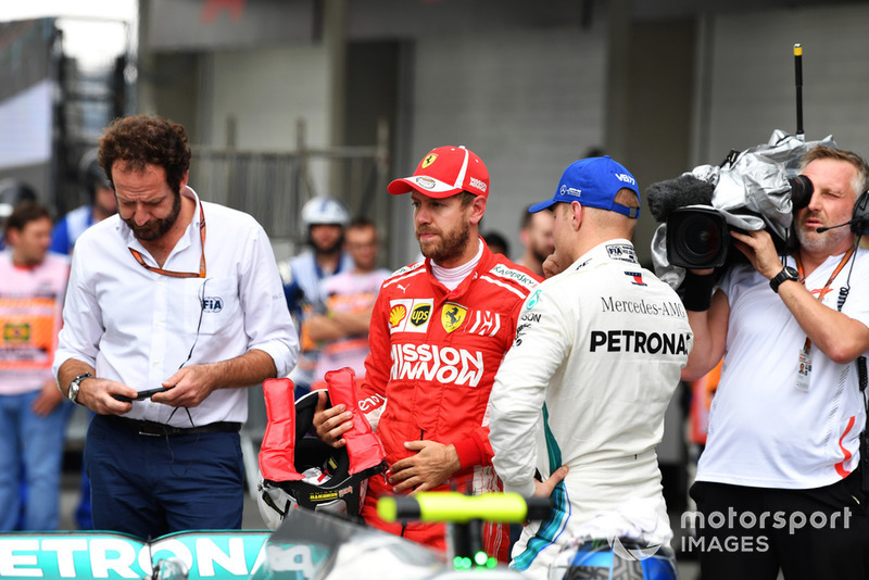 Matteo Bonciani, FIA Media Delegate, Sebastian Vettel, Ferrari and Valtteri Bottas, Mercedes AMG F1 in Parc Ferme