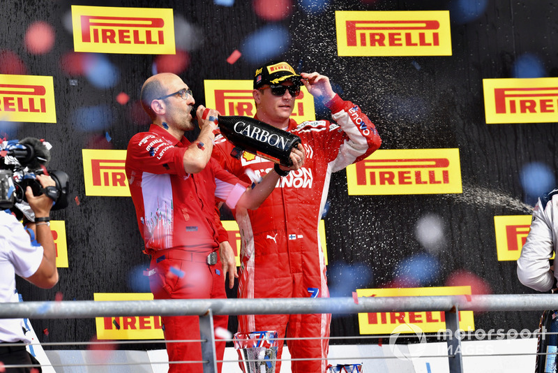 (L to R): Carlo Santi, Ferrari Race Engineer and Kimi Raikkonen, Ferrari celebrate with the champagne on the podium 