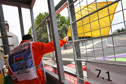 A marshal waves the yellow flag