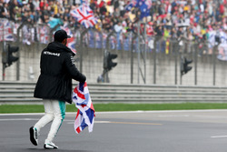 Lewis Hamilton, Mercedes AMG, takes to the track to entertain the fans and picks up a Union Flag
