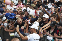 Race winner Lewis Hamilton, Mercedes AMG F1, takes pictures with fans after the race