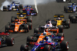Marcus Ericsson, Sauber C36, locks-upasses a front wheel at the rear of the pack. Carlos Sainz Jr., Scuderia Toro Rosso STR12, a midfield group of Fernando Alonso, McLaren MCL32, Sergio Perez, Sahara Force India F1 VJM10, Stoffel Vandoorne, McLaren MCL32, Nico Hulkenberg, Renault Sport F1 Team RS17, Jolyon Palmer, Renault Sport F1 Team RS17