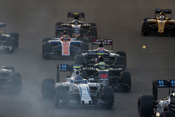Valtteri Bottas, Williams FW38, leads Jenson Button, McLaren MP4-31 and Romain Grosjean, Haas VF-16, at the start