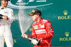 Lewis Hamilton, Mercedes AMG, deuxième et Sebastian Vettel, Ferrari, vainqueur, s'aspergent de champagne sur le podium