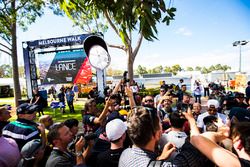 Lewis Hamilton, Mercedes AMG, signs autographs for fans, while throwing his cap into the air