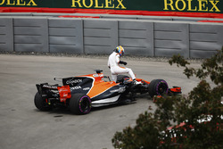 Fernando Alonso, McLaren, extracts himself from a leaking car in FP1