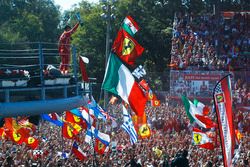 Third place Sebastian Vettel, Ferrari, shows his trophy to the crowd