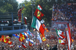 Third place Sebastian Vettel, Ferrari, shows his trophy to the crowd