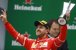 Sebastian Vettel, Ferrari, celebrates with his trophy on the podium