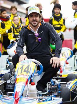 Fernando Alonso, McLaren, poses on a kart