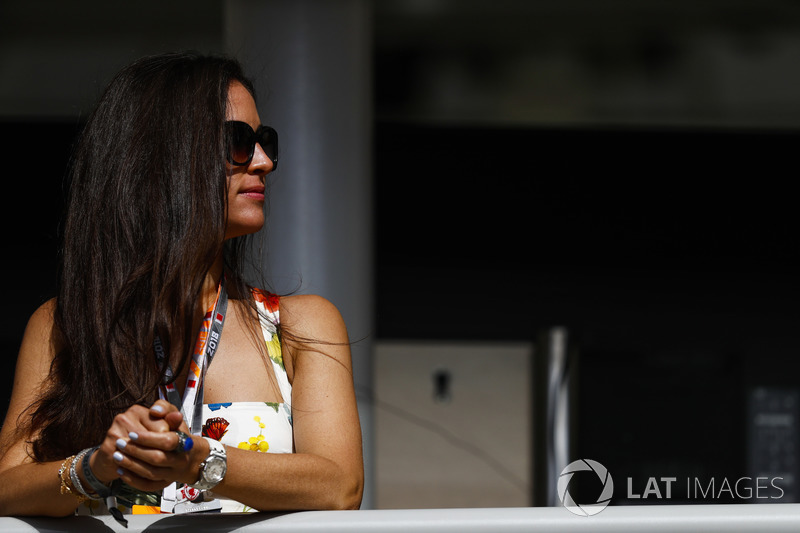 A fan watches from near the garages