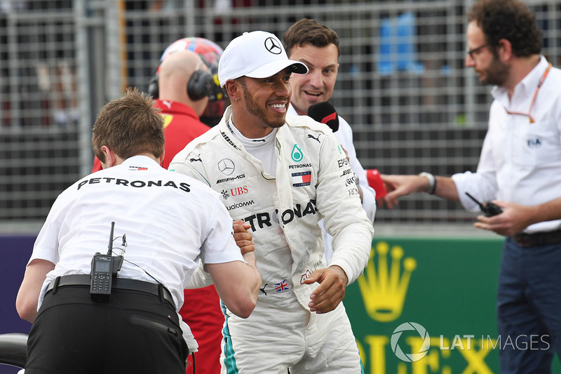 Pole sitter Lewis Hamilton, Mercedes-AMG F1 celebrates in parc ferme as Will Buxton, looks on