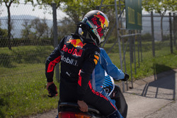 Daniel Ricciardo, Red Bull Racing crashed in FP1 and gets a lift on a scooter