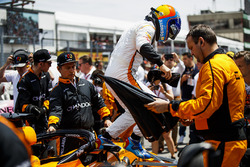 Fernando Alonso, McLaren, jumps out of his car on the grid