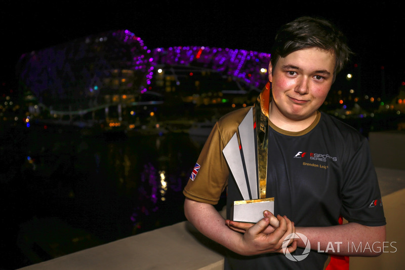 Brendon Leigh celebrates on the podium after winning the E-Sports event