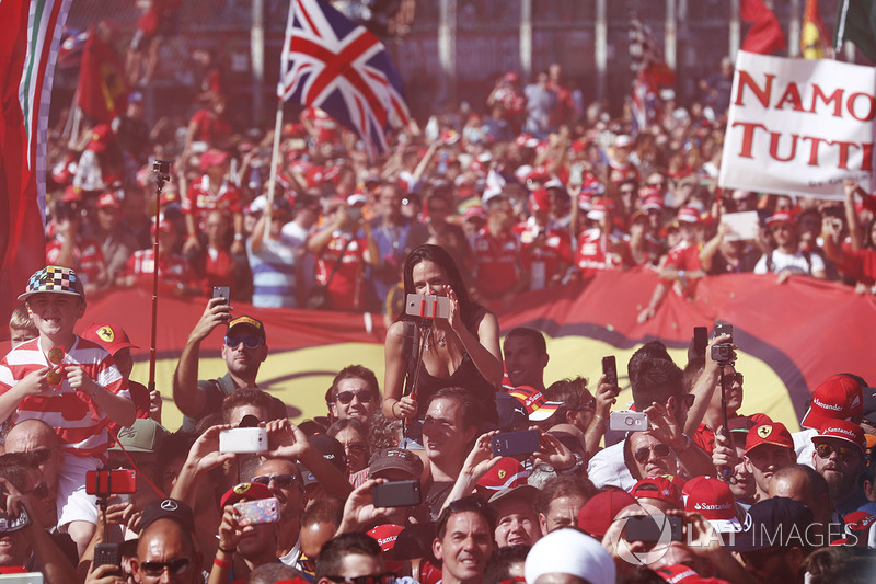 A throng of Ferrari fans invade the circuit after the race