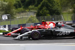 Kimi Raikkonen, Ferrari SF70H, battles Romain Grosjean, Haas F1 Team VF-17. Felipe Massa, Williams FW40, follows