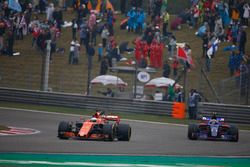 Fernando Alonso, McLaren MCL32, leads Carlos Sainz Jr., Scuderia Toro Rosso STR12