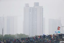 A gloomy skyline behind a grandstand full of fans