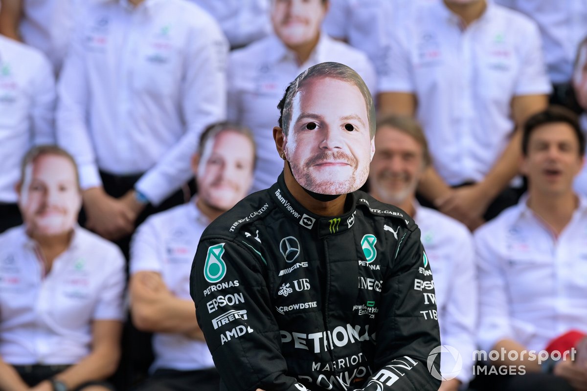 Lewis Hamilton, Mercedes, wears a Valtteri Bottas mask