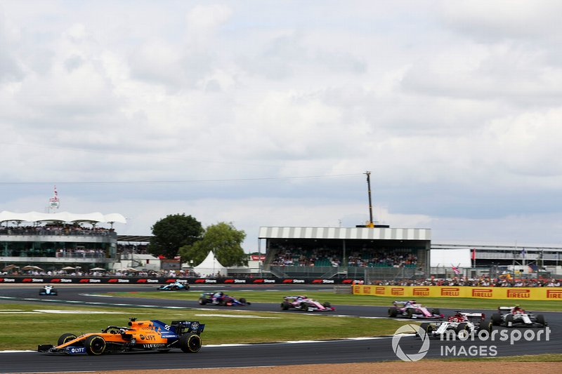 Carlos Sainz Jr., McLaren MCL34, leads Kimi Raikkonen, Alfa Romeo Racing C38, and Antonio Giovinazzi, Alfa Romeo Racing C38