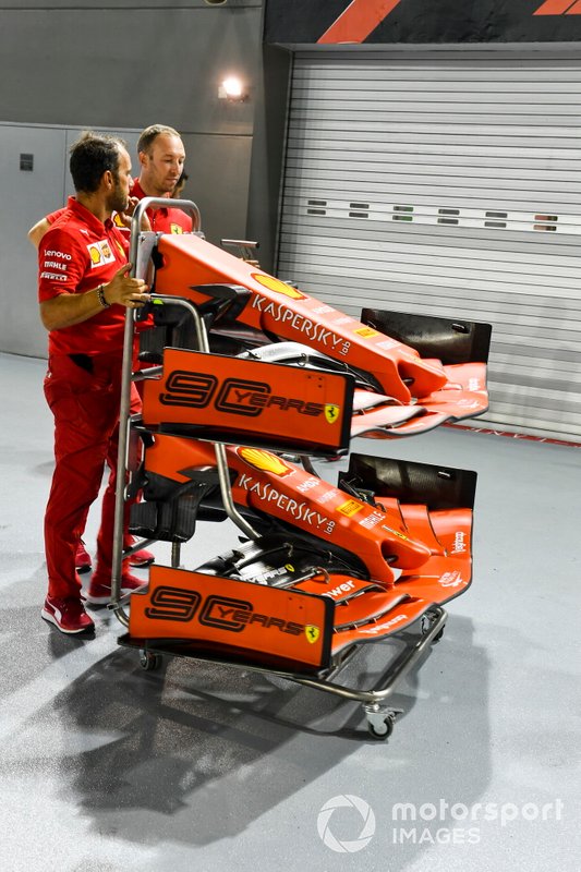 Front wing of Ferrari SF90 on a trolly being pushed by Ferrari mechanics