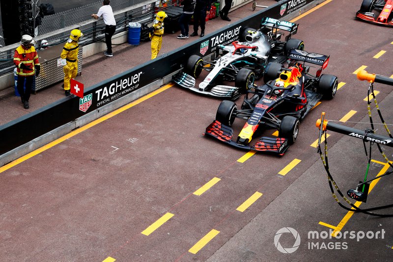 Valtteri Bottas, Mercedes AMG W10 and Max Verstappen, Red Bull Racing RB15 battle in the pit lane