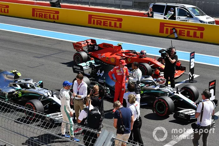 Charles Leclerc, Ferrari, talks with pole man Lewis Hamilton, Mercedes AMG F1, on the grid after Qualifying