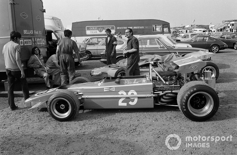 Mechanics with Silvio Moser's Bellasi Ford behind the transporter