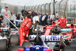 Sebastian Vettel, Ferrari, examines a Mercedes AMG F1 W08 in parc ferme