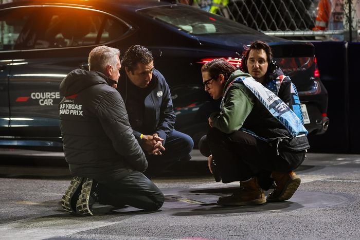 Track officials inspect a manhole cover