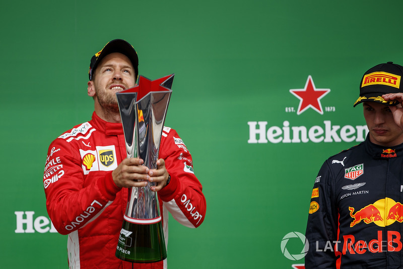 Sebastian Vettel, Ferrari, 1st position, with his trophy and Max Verstappen, Red Bull Racing, 3rd po