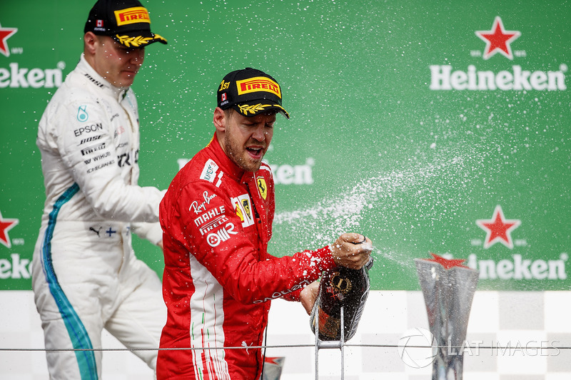 Valtteri Bottas, Mercedes AMG F1, 2nd position, and Sebastian Vettel, Ferrari, 1st position, celebra