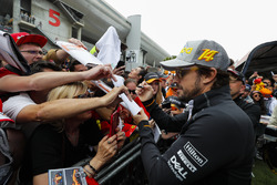 Fernando Alonso, McLaren, signs autographs for fans