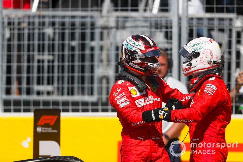 Charles Leclerc, Ferrari, congratulates his team mate, Sebastian Vettel, Ferrari, on pole position