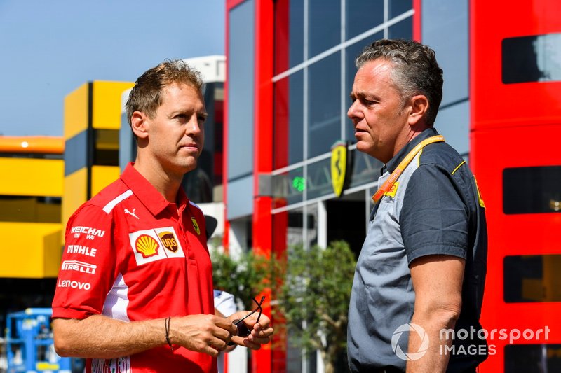 Sebastian Vettel, Ferrari an Mario Isola, Racing Manager, Pirelli Motorsport parla nel paddock
