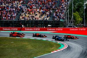 Lewis Hamilton, Mercedes AMG F1 W10, Valtteri Bottas, Mercedes AMG W10, and Sebastian Vettel, Ferrari SF90, race side by side ahead of Max Verstappen, Red Bull Racing RB15, Charles Leclerc, Ferrari SF90, and Pierre Gasly, Red Bull Racing RB15, in the first corner at the start