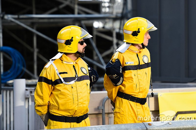 Marshals in the pit lane