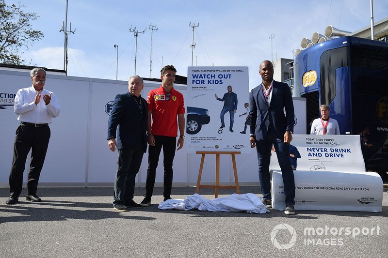 Jean Todt, President, FIA, Charles Leclerc, Ferrari, and Footballer Didier Drogba unveil a poster at a safer driving campaign