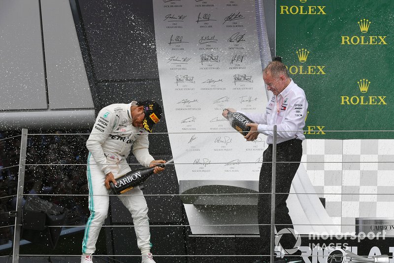 Lewis Hamilton, Mercedes AMG F1, 1st position, sprays Champagne at his team mate on the podium
