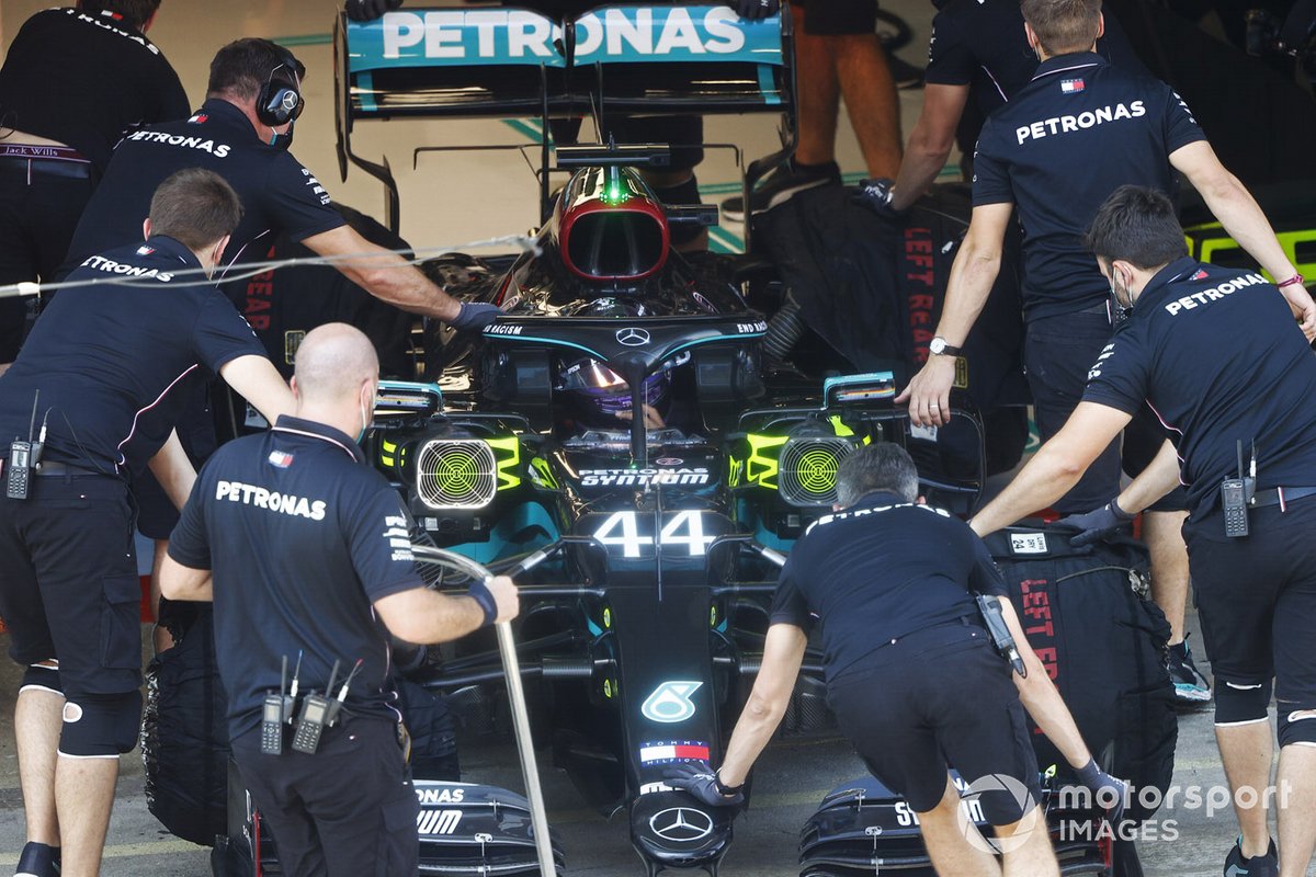 Lewis Hamilton, Mercedes F1 W11 EQ Performance, is returned to the garage